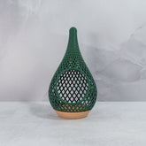 "Sitting, front-facing, empty WOOD AND GREEN TEARDROP planter, showcasing its natural wood base and refreshing green pattern."